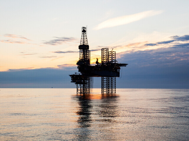 Offshore oil rig against a setting sun